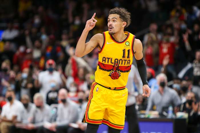 Atlanta Hawks guard Trae Young (11) celebrates after a basket against the Charlotte Hornets in the second half at State Farm Arena.
